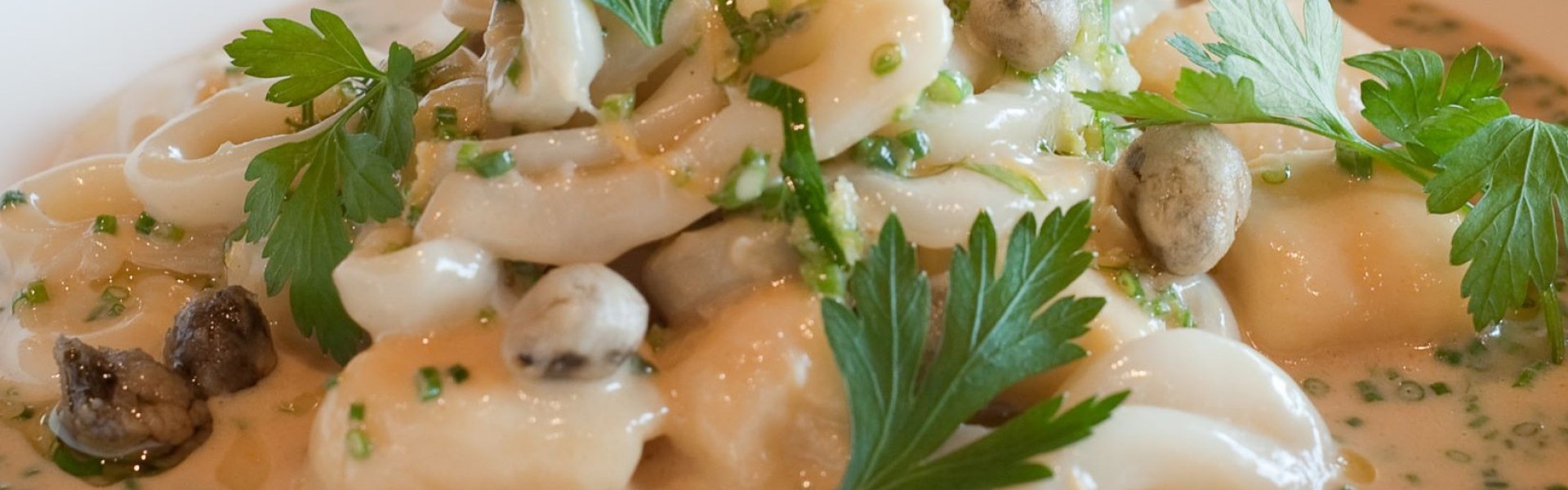 Calamari cooked sous vide | hand made lemon gnocchi | crispy capers | gremolata | Champagne veloute
